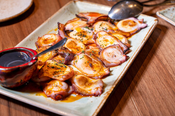 Plate of Grilled octopus with olive oil. High quality photography