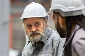 Industrial Engineer in Hard Hats.Work at the Heavy Industry Metal Sheet Manufacturing Factory....