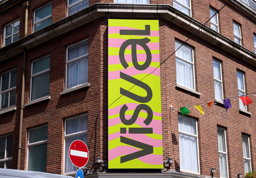 A blank vertical canvas is displayed on a building's facade in Dublin