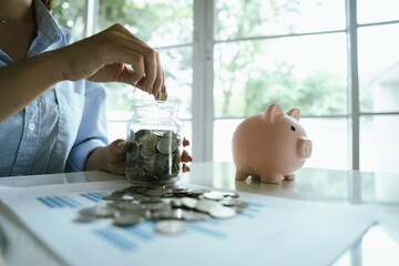 An adult holds a coin, which symbolizes finance, investing, saving, retirement planning, profits,...