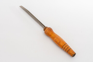 A worn kitchen tool with a serrated metal blade and a wooden handle, isolated on a clean white...