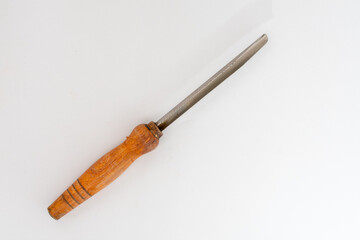 A worn kitchen tool with a serrated metal blade and a wooden handle, isolated on a clean white...
