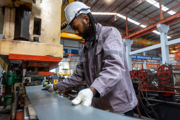 Industrial Engineer in Hard Hats.Work at the Heavy Industry Metal Sheet Manufacturing Factory....