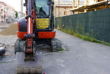 Construction site activity with an excavator and surrounding work environment in a city setting
