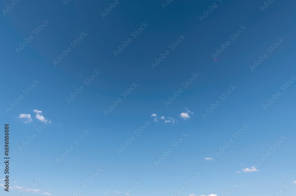 Poster a bright sky with sparse white clouds and no clouds in sight