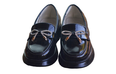 Shiny black girls' shoes stand on a white background
