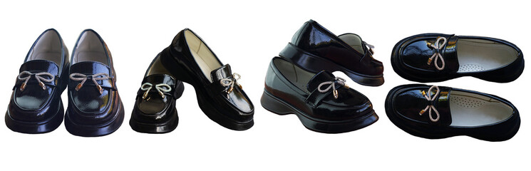 Shiny black girls' shoes stand on a white background
