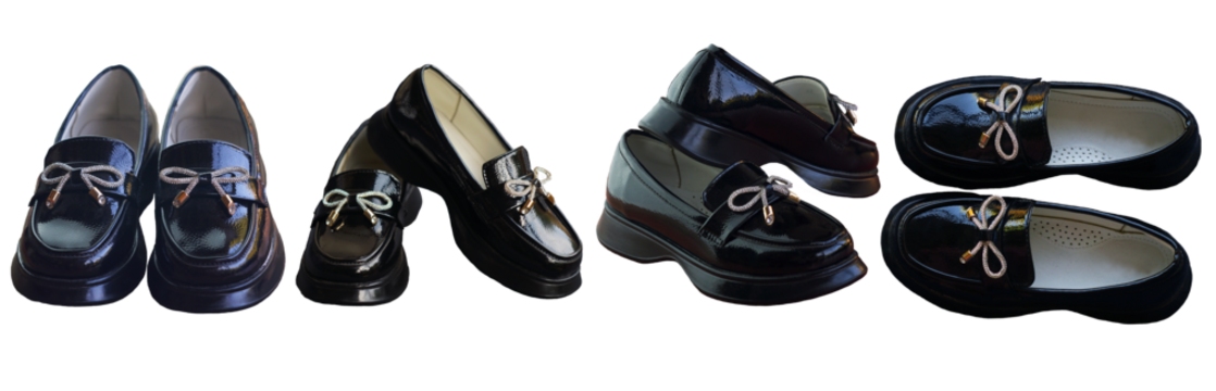 Shiny black girls' shoes stand on a white background