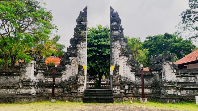 The iconic Balinese temple gate with ornate stone work highlights the spiritual atmosphere and cultural artistry that define the island timeless architectural traditions.