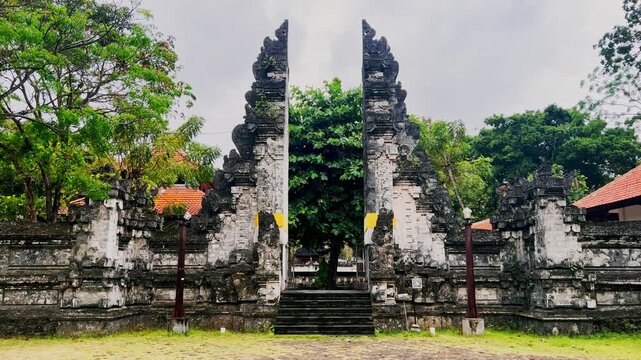 Traditional Balinese temple gate with intricate carvings represents spiritual devotion and cultural heritage showcasing the island unique artistry and architectural beauty.