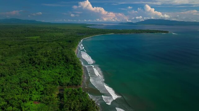Cape Wom beach Dogreto Bay Madang Wewak Harbor View Papua New Guinea aerial drone Kavieng Vanimo Tufi coastline sunny blue sky clouds untouched remote Mushu Island tropical shore waves downward left