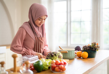 Muslim woman wearing hijab preparing fresh vegetables and fruits in kitchen, healthy lifestyle clean eating cooking, wellness and tradition, nutrition family care, vitamins supplement, halal cooking