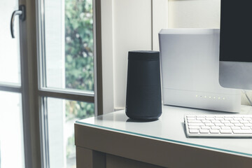 Smartphone, wifi speaker, router and computer on desk. Technology, domotics, home automation concept