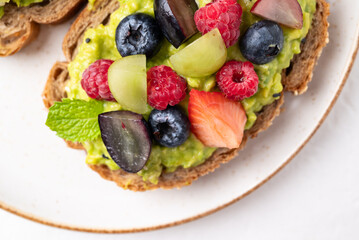 Avocado toast with strawberry, blueberry, raspberry and grape. Healthy eating