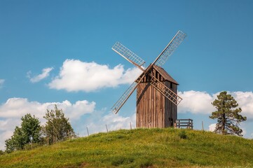 Old wooden windmill standing on a hillside