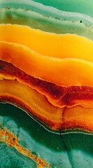 Striking close-up view of colorful agate stone showcasing vibrant layers of orange, yellow, and green hues, perfect for nature and texture themes in art and design.