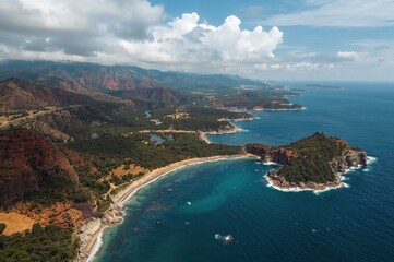 Obraz premium Bird's-eye view of two bodies of water merging at a narrow landform, showcasing the vivid blue meeting line between the river and ocean, with wild landscape and clear skies around.