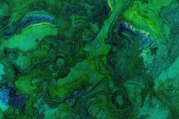 Artistic alcohol ink texture with green and blue hues. Unique background for creative projects.