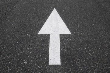 Abstract road design featuring white arrow pattern on asphalt