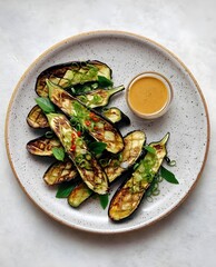 Grilled Eggplant with Asian-Inspired Sauce on a Rustic Plate