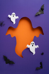 Decorative vertical Halloween theme with ghost and bats cutouts arranged on a colorful purple backdrop