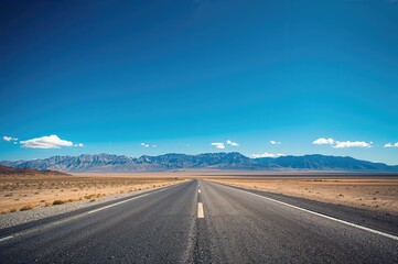 Naklejka premium Wide-angle shot from ground level featuring a clear sky and mountain scenery, ideal for showcasing vehicles or products