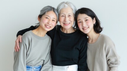 Fototapeta premium Family portrait of smiling mother being hugged by her daughters