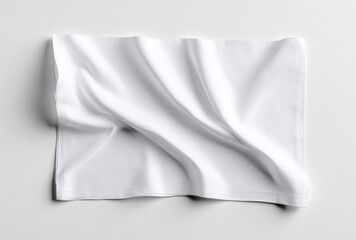 Fototapeta premium Wrinkled white fabric laying flat on a white surface, soft shadows defining the folds and edges