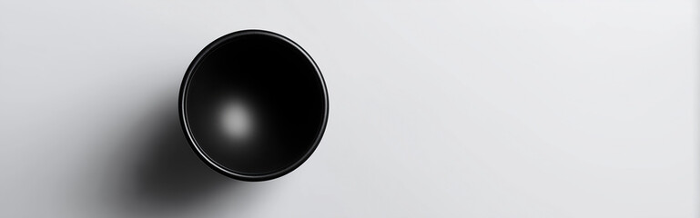Simple black ceramic bowl sits against clean white background with shadow.