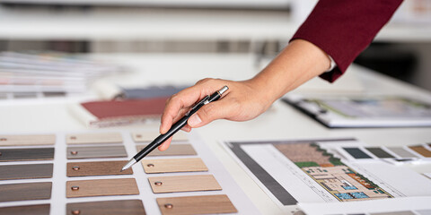 Close up hand of Interior design, working  designers or decorator choosing finishing material ,...