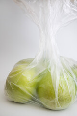 Transparent recycled eco bag with fresh green organic apples isolated on white background