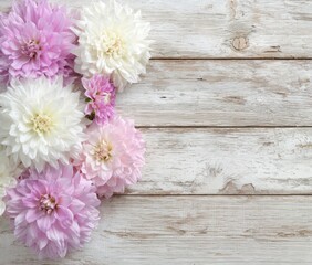 Floral arrangement of pastel-colored dahlias on rustic, whitewashed wooden planks creates a soft, delicate, and natural springtime aesthetic