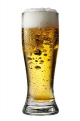 Chilled glass of golden beer with abundant white foamy head, isolated against a white background