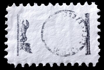 Close-up of a used, canceled postage stamp with faded circular mark on a black backdrop