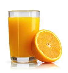 Refreshing orange juice in a clear glass beside half an orange, isolated against white