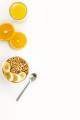 Healthy granola and orange juice for colorful breakfast on white background top view mock-up