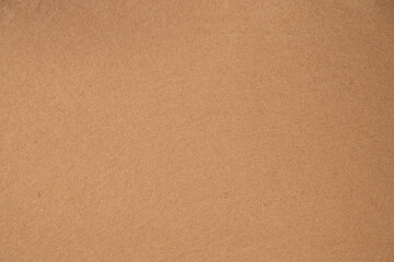 Beige felt fabric texture background close up for design use