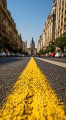 Fototapeta premium Street view with a blurry grand building in the distance under a clear sky, framed by buildings