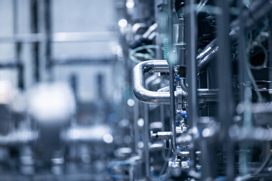 Industrial beer production: pipes and machinery in brewery factory setting