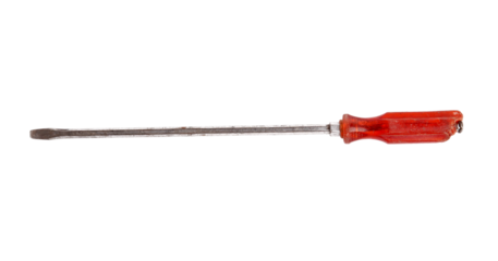 A used flat head screwdriver with a red handle isolated black.