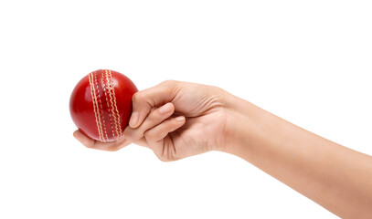 Players hand gripping a vibrant red cricket ball, isolated