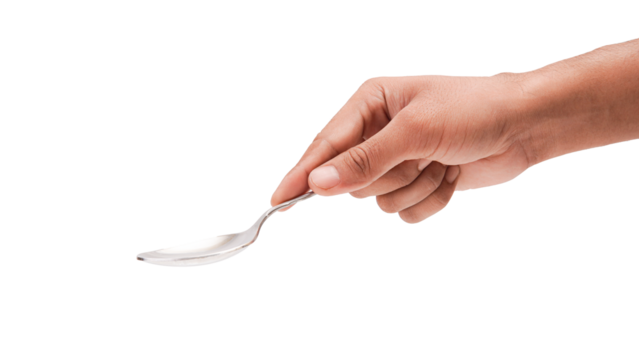 Hand holding a shiny silver spoon, isolated a