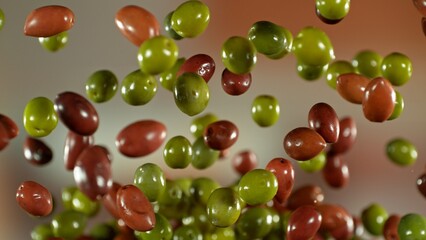 Freeze motion of flying fresh olives, isolated on gradient background.