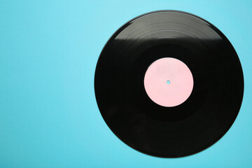Vinyl record on blue background. Space for text