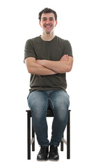 Young man sitting on a chair waiting with arms folded. Full length seated, contented male smiling...