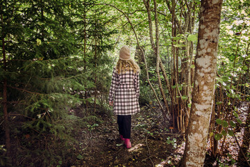 A teenage girl takes a therapeutic mental health walk. She is walking through an autumn forest on a...