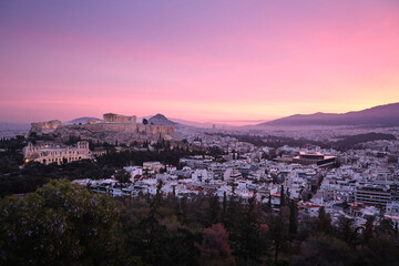Sunrise view of the Acropolis, Parthenon and Acropolis Museum over the city of Athens, Greece, with pastel sky and urban landscape.