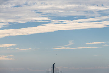 Fototapeta premium idyllic cloudscape with a suspension bridge