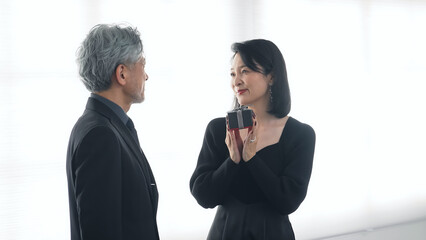 Middle-aged couple giving a gift