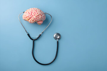 Brain rests on stethoscope against blue backdrop, symbolizing mental health awareness and the importance of neurological examination for cognitive wellbeing.